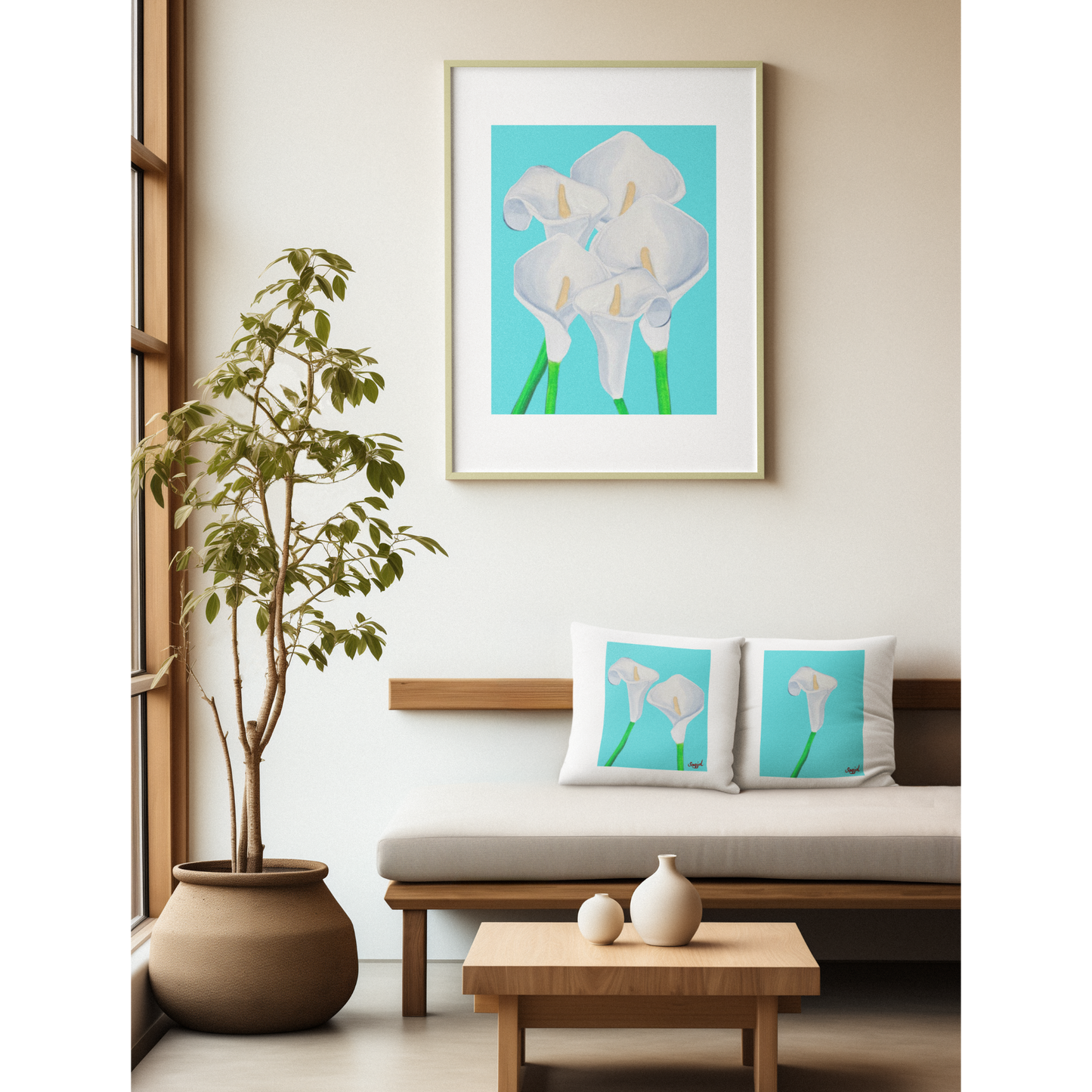 Framed artwork of white flowers on a wall in a living room with matching cushions.